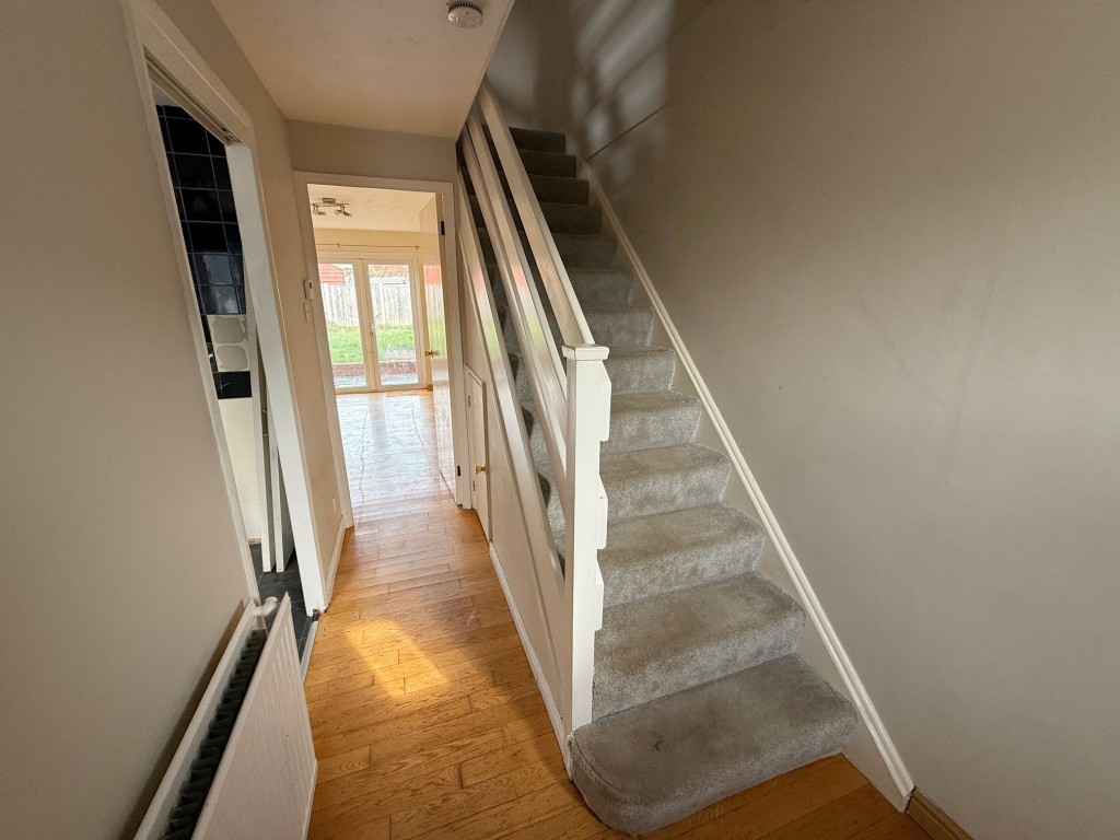 Lot: 6 - END-TERRACE HOUSE FOR IMPROVEMENT - Stairs to first floor with door to kitchen and reception room